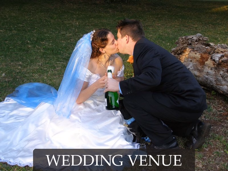 Bride and groom kissing on the lawn at Leopard Walk Lodge